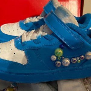 Toddler Nike wearing blue and white shoes